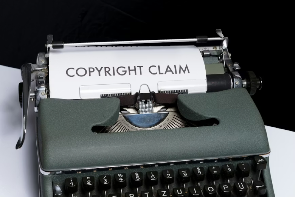 A vintage typewriter with a sheet of paper reading Copyright Claim.