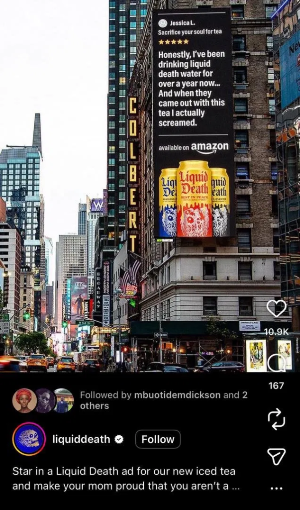 Liquid Death's dark, heavy-metal-style Times Square billboard featuring a customer review headlined "Sacrifice your soul for tea" above three iced tea cans.
