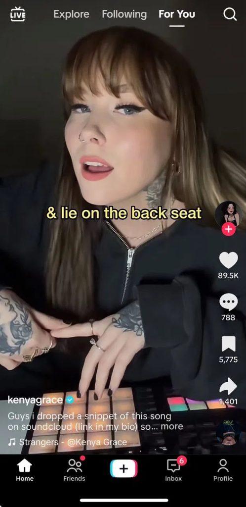 Kenya Grace's verified TikTok post of her self-produced single "Strangers," showing her on her drum pads with the "Strangers" sound tag and 89K+ likes; the original organic post behind the song's viral spread.