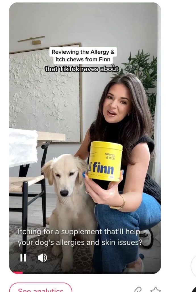 TikTok ad showing a creator holding a yellow Finn allergy chews canister next to her dog, with a "Reviewing the chews TikTok raves about" overlay.