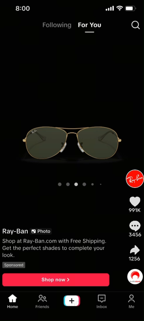 TikTok Catalog ad from Ray-Ban featuring a classic aviator sunglasses product image with Sponsored label and carousel preview dots.