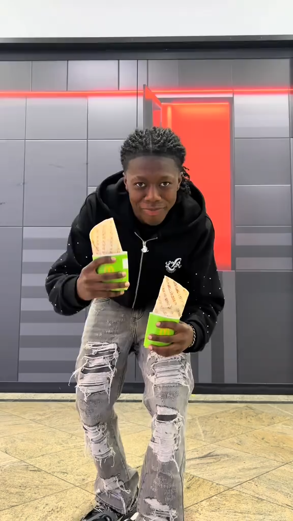 Creator-led TopView ad for McDonald's Germany featuring a young creator in streetwear holding two McWrap products against a modern urban backdrop.