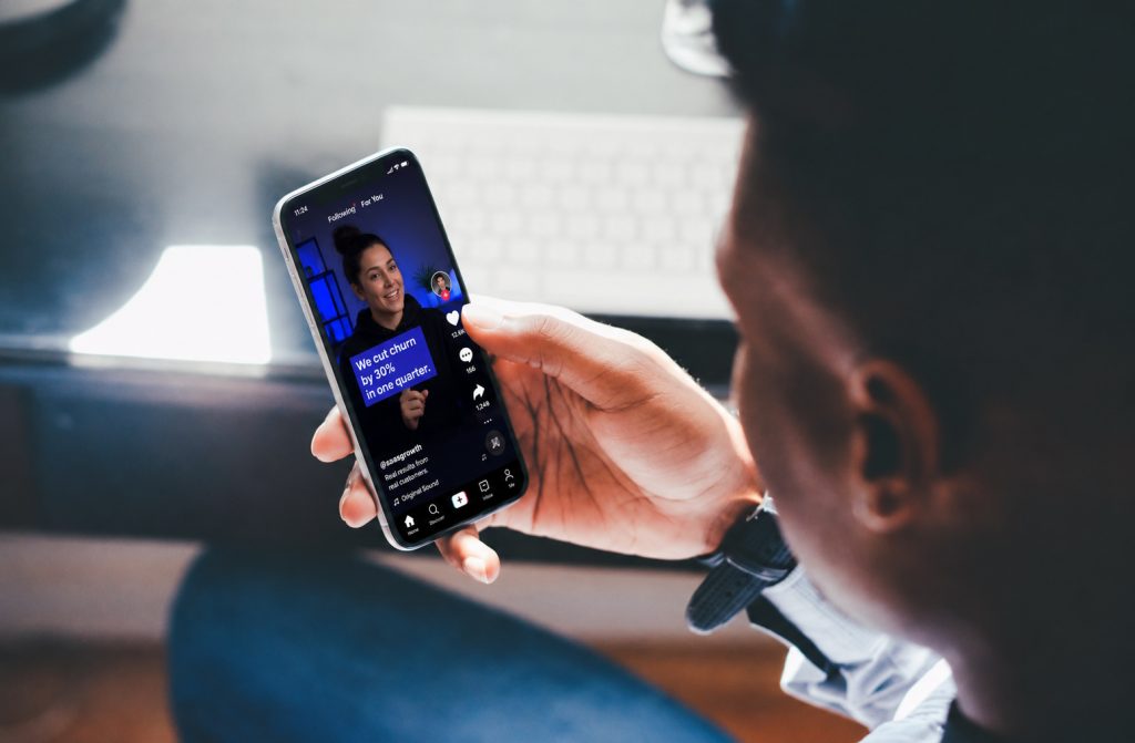 A young person using their phone, showing the demographics TikTok mainly targets.