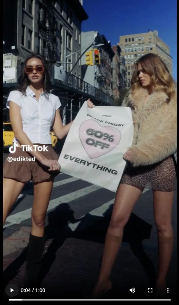 Edikted TikTok ad: two models on a New York street holding a "Black Friday — 60% OFF Everything" poster, with the @edikted handle and TikTok watermark.