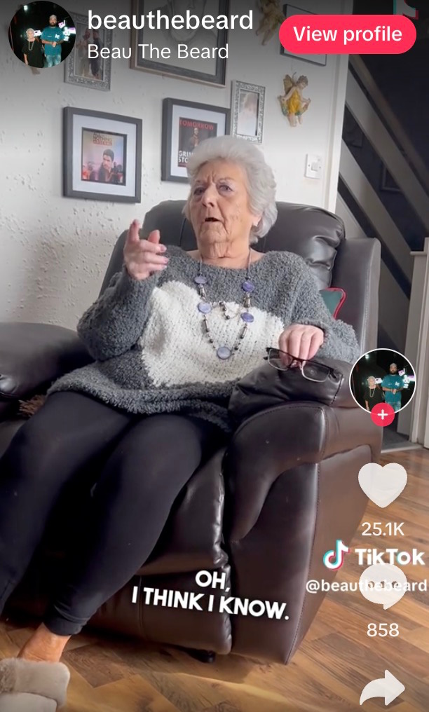 Elderly woman sitting in leather recliner on TikTok video.