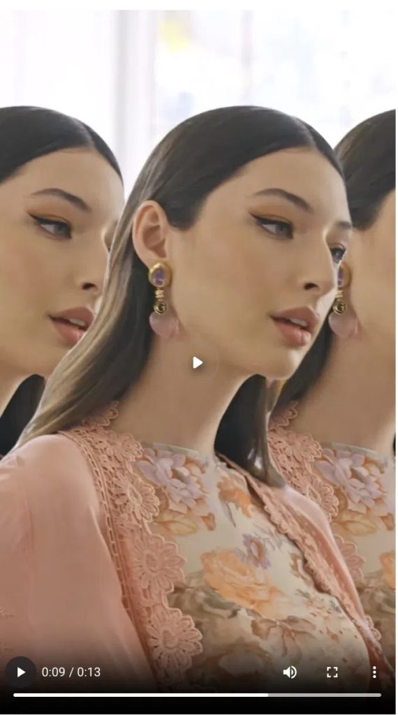 GUESS In-Feed TikTok ad: a polished, brand-produced fashion shot of a model in a floral lace outfit, illustrating the standard In-Feed ad format that runs from a brand's ad account.