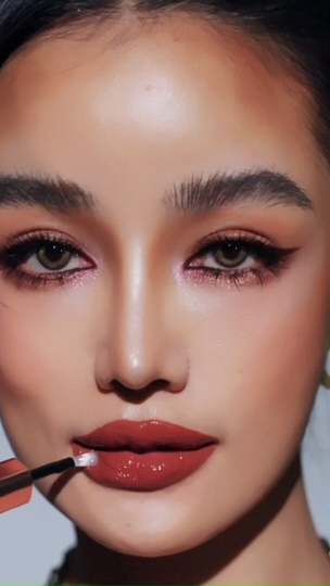 TikTok ad of a woman putting lipstick on in a Kathy Cosmetic TikTok ad.