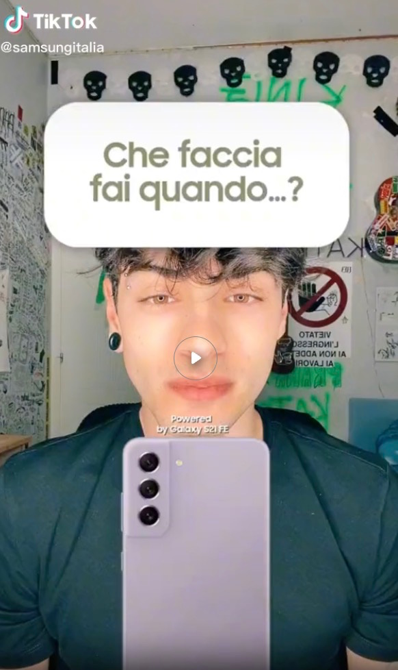 Young person holds a lilac Galaxy S21 FE phone in TikTok ad.