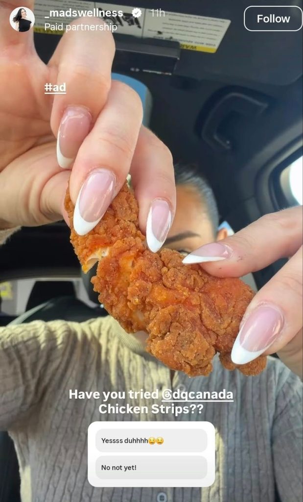Screenshot of Maddi Cerasuolo holding Dairy Queen Canada’s Chicken Strips close to the camera 